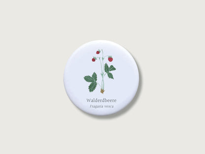 Runder, matter Pflanzen-Magnet (Ø 55 mm) mit kratzfestem Schutz-Finish. Gezeigt wird eine detailreiche, handgemalte botanische Illustration einer Walderdbeere auf weißem Grund.