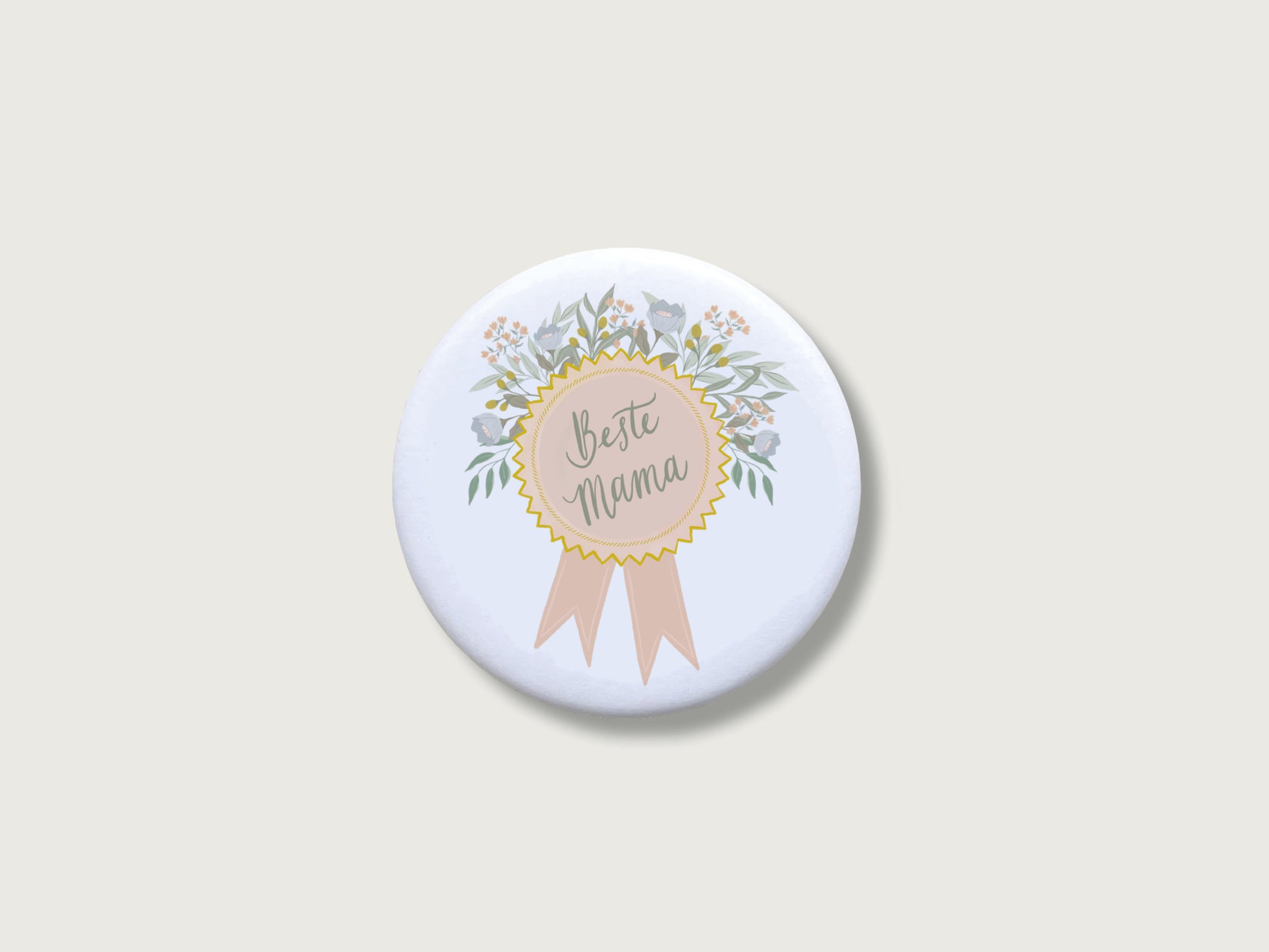 Liebevolles Geschenk zum Muttertag oder Geburtstag: Runder, weißer Kühlschrankmagnet in Form einer Ehrenmedaille mit Schleife, einem feinen Blütenkranz in sanften Naturtönen und dem handillustrierten Schriftzug Beste Mama. Das dekorative Motiv für die Magnetwand ist mittig auf einem schlichten, neutralen, hellen Hintergrund platziert.